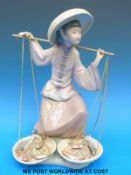 A Lladro figure of an oriental fish seller (24cm tall)