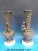 A pair of Art Nouveau spelter vases each set with a young child,