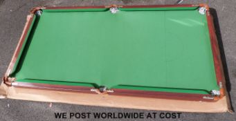 A small snooker/billiard table and accessories