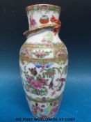 A 19thC Chinese famille rose vase with dragon in relief to the top (25.