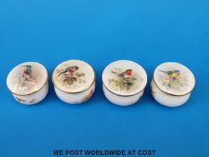Four Royal Worcester miniature pill boxes all decorated with birds all signed Powell and with puce