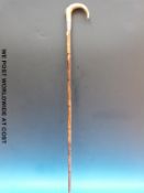 A bamboo walking stick with a horn handle and hallmarked silver collar