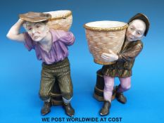 A pair of Royal Worcester figural spill vases or sweetmeat dishes in the form of peasants carrying