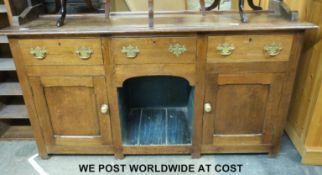 An oak dog kennel dresser with plate rack above,