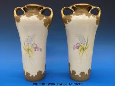 A pair of hand decorated Austrian amphora vases with floral design (height 33cm)