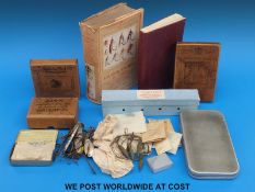 A collection of vintage fishing tackle including large bronze hooks, spinners,