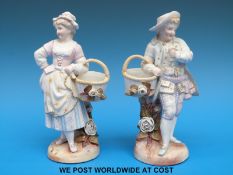 A pair of continental figures of a swain and a maid carrying baskets (18cm tall)