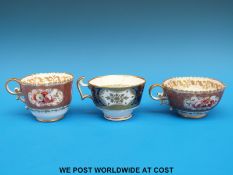 Two Swansea porcelain teacups with floral cartouches against a pink ground and another Swansea cup