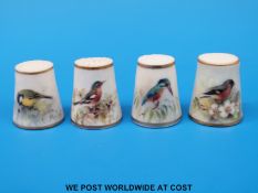 Four Royal Worcester thimbles hand decorated with birds,