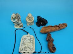 Two Chinese bone figures, two wooden netsukes one in the form of a mermaid and the other a dog,