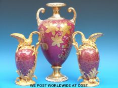 A pair of pedestal ewers with swan handles (23cm tall) and a pedestal vase (36cm tall)