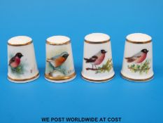 Four signed Royal Worcester thimbles hand decorated with birds, all with black stamps (tallest 2.