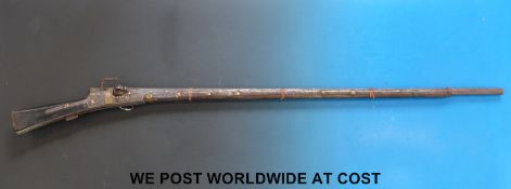 An Afghan matchlock rifle with wooden stock and all metal forend and mounts,