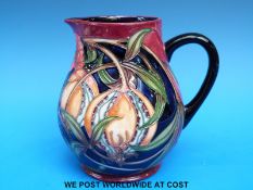 A Moorcroft jug decorated with poppies and pomegranates dated 2003 (14cm tall)