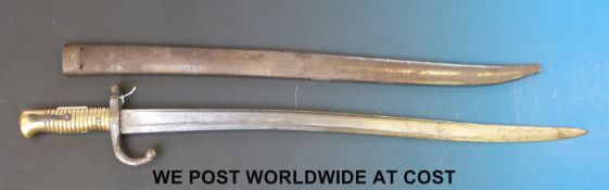 A late 19thC French brass handled bayonet indistinctly etched to edge of blade,