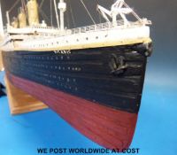 A well detailed model of the Titanic on stand together with books on the subject