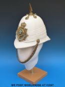 A Royal Regiment of Wales bandsman's helmet in white blanco finish