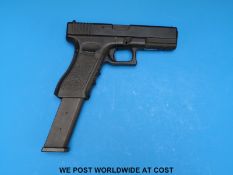 A Glock GS18C semi-automatic airsoft/BB pistol with extended 50 round magazine,