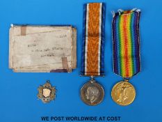 A pair of WWI medals awarded to 65202 Pte E.G.Tyler Devon Regiment and a silver fob for the G.S.F.