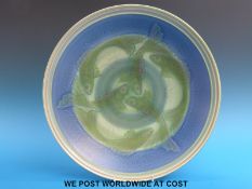 A Poole Pottery pedestal bowl or charger decorated with fish, 35.5cm in diameter.