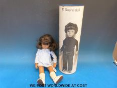 Sasha doll with dark skin, brown eyes and long dark brown hair,