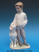 A Lladro figure of a boy with his dog (25cm tall)