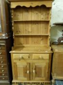 A pine dresser with plate rack above,
