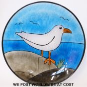 A stained glass charger decorated with a seagull,
