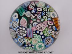 Two John Deacons glass paperweights, one scrambled featuring many initialled canes (7.