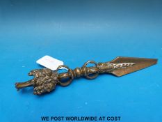 A Tibetan brass phurba decorated with a horse and masks