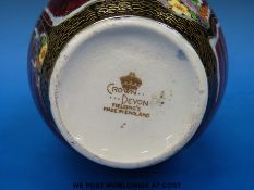 A Crown Devon lustre vase decorated with flowers,