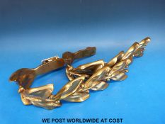 A pair of heavy gilt brass foliate curtain hold backs with brackets