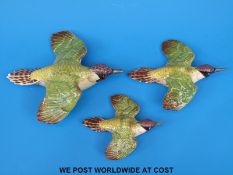 A set of three Beswick graduated woodpecker wall plaques