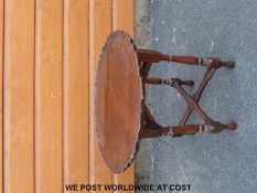 A small mahogany table with piecrust edge