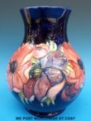 A Moorcroft vase decorated in the Anemone pattern with green Moorcroft signature to base (24cm