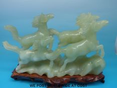 A hardstone/ jadeite figure of galloping horses on stand