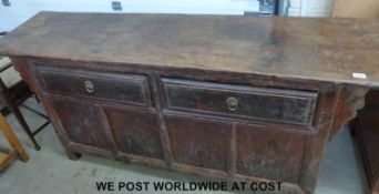 A late 19thC/early 20thC Chinese elm side board with two drawers above (Approximately L188 x W46cm