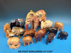 A collection of wooden elephants of various sizes (largest 21cm tall)