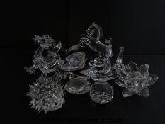 Nine Swarovski crystal ornaments including a dragon, hedgehog, ship, flower, rocking horse etc,
