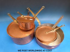 A near set of four 19thC copper and brass pans,