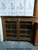 An oak glazed bookcase (W124 x D36 x H115cm)