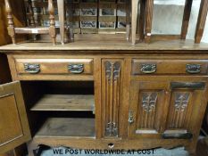 An Arts & Crafts / Art Nouveau sideboard fitted two drawers and two cupboards with beaten copper