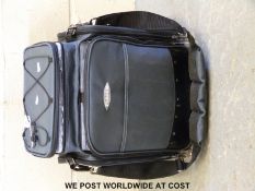 A Fladen canvas fishing bag with eight plastic multi section boxes, side pockets,