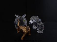 Four Swarovski and similar cut glass owls and elephants,