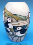 A Moorcroft vase decorated with puffins,