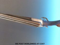 Unnamed 12 bore double barrelled side by side shotgun with chequered grip and forend and double
