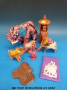 A collection of silk elephants together with a terracotta example,