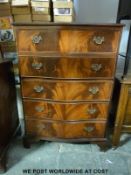 A reproduction serpentine fronted chest of five drawers (W73 x D44 x H104cm)