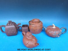 Two Yixing teapots together with two similar teapots