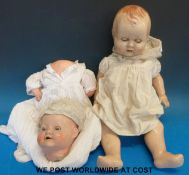 Two dolls, one with open mouth,